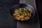 Close up lebanese or syrian salad tabbouleh made of bulgur or couscous, poultry meat, parsley and tomato