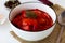 Close-up lecho of tomatoes and sweet paprika with ingredients on the table