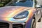 Close-up LED headlight expensive car part with exclusive iridescent painting. Vehicle covered with vibrant chameleon