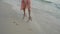 Close up leg of young woman walks barefoot on sand on the Beach
