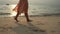 Close up leg of young woman walks barefoot on sand on the Beach