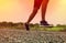 Close-up Legs of Asian young man is jogging on dirt road in the park. Healthy lifestyle