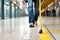 Close-up of the legs a blind man with a cane walking on a tactile tile. Concept Accessibility streets of the city for visually