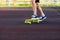 Close up legs in blue sneakers riding on yellow skateboard in motion. Active urban lifestyle of youth, training, hobby
