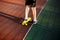 Close up legs in blue sneakers riding on yellow skateboard in motion. Active urban lifestyle of youth, training, hobby, activity