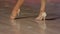 Close-up of legs of dancing couples in ballroom. Slow motion.