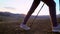 Close-up of legs of hiker tourist traveler woman with trekking poles walking