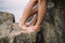 Close up legs of kissing couple near the sea on the rocks