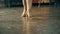Close-up of the legs of a man and a woman dancing a pair of ballroom dance in the room. Dance moves of the tango.