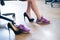 Close-up of legs of an office female employee with foot pain. A woman changes high black suede heels to more comfortable