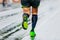 close-up legs runner athlete running marathon in black compression socks