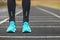 Close up of legs in running shoes standing on asphalt.