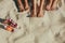 Close up of legs of three women beside bottles of soft drinks at