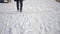 Close-up legs walking in street outdoors in snowy Russian winter