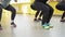 Close-up of legs of women doing squats in a fitness club. Group training. Healthy lifestyle