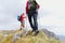 Close-up of legs of young hikers walking on the country path. Young couple trail waking. Focus on hiking shoes