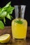 Close-up of lemon pitcher with slices and mint on dark wooden table
