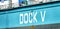 Close-up of the lettering of Dock V in the port of Hamburg opposite the landing stages