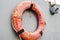 Close up of life preserver rings hanging off an old boat in a field of junk boats in Homer, Alaska. Seen from a walking