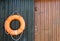 Close-up of a lifebelt on a wooden door.