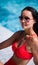 Close up lifestyle portrait of Cute girl swimming in pool, traveling and enjoy her summer vacation, perfect skin,trendy