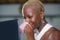 Close up lifestyle portrait of young classy attractive and happy black african american woman drinking coffee or tea working on la