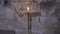 Close up for lighted church candle standing in front of the cement wall near the icon, religion concept. Footage. The