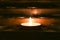 Close up of lighted tealight candle. Burning candle