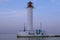 Close up lighthouse in Odessa sea port in the evening at sunset. Landmark, landscape, copy space