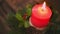 Close up lighting red Christmas candle on wooden table