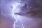 Close up of lightning strike on the night cloudy sky