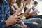 Close Up Of A Line Of High School Students Using Mobile Phones