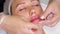 Close-up. lip augmentation procedure. Surgeon, in medical gloves, kneads and massages female lips to evenly distribute