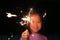 Close up little Asian girl holding fire sparklers