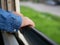 Close up of little baby`s hands holding on a frame of an opened window on a traveling train