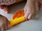 Close up of little baby`s hands rolling on playdough on the house floor