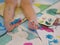 Close up of little baby`s toes and toenails, 2 years old, being painted, messy, dirty