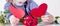 Close up little child girl with flowers holding two red hearts. Wedding, Valentine, love concept