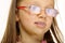 Close up little girl in glasses doing fun saliva bubbles