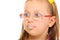 Close up little girl in glasses doing fun saliva bubbles
