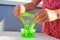 Close up of a little girl is hand playing a green slime