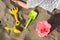 Close up little girl hand with toy shovels and bucket