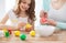 Close up of little girl and mother coloring eggs