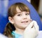 Close-up of little girl opening his mouth wide during inspection