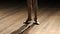 Close-up of little girl`s ballerina feet on stage.