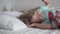 Close-up of the little girl stretches and wakes up in her bed