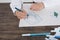 Close up of little girl in white blouse which is focused on drawing. Preschooler is learning how to draw. Kindergarten and school.