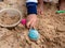 Close up little hand asian young child playing toy on sand. Preschool learning ef concept.