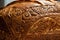close-up of loaf of bread, with intricate designs and patterns created by the baker