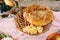 Close-up of a loaf of fresh aromatic bread in a plate with ham with lard and hard cheese on a plate with patterns near a